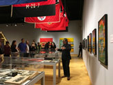 Artist Glexis Novoa from Climate Change: Cuba-USA gives a gallery tour. photo by Tony Palms.